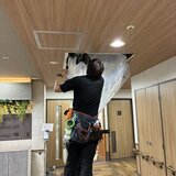 スーパーコート高石羽衣の共用部にて、業者が養生シートを使い天井埋込型エアコンを洗浄クリーニングしている様子
